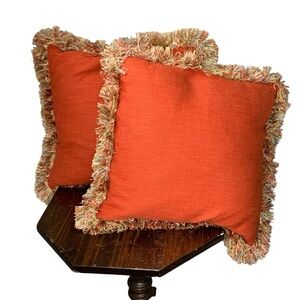 Set of two square cotton terracotta down‎ pillows with multi fringe trim 18”.